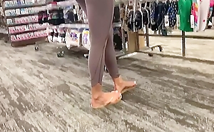 Spying Hottie Round Sexy Leggings Coupled with Flip Flops At The Socks Store